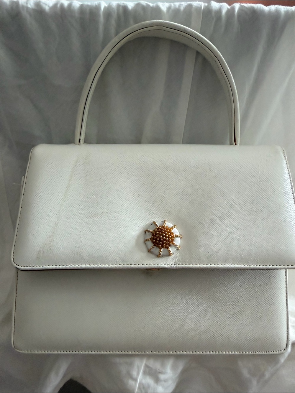 Elegant White Top-Handle Satchel with Gold Sunburst Accent